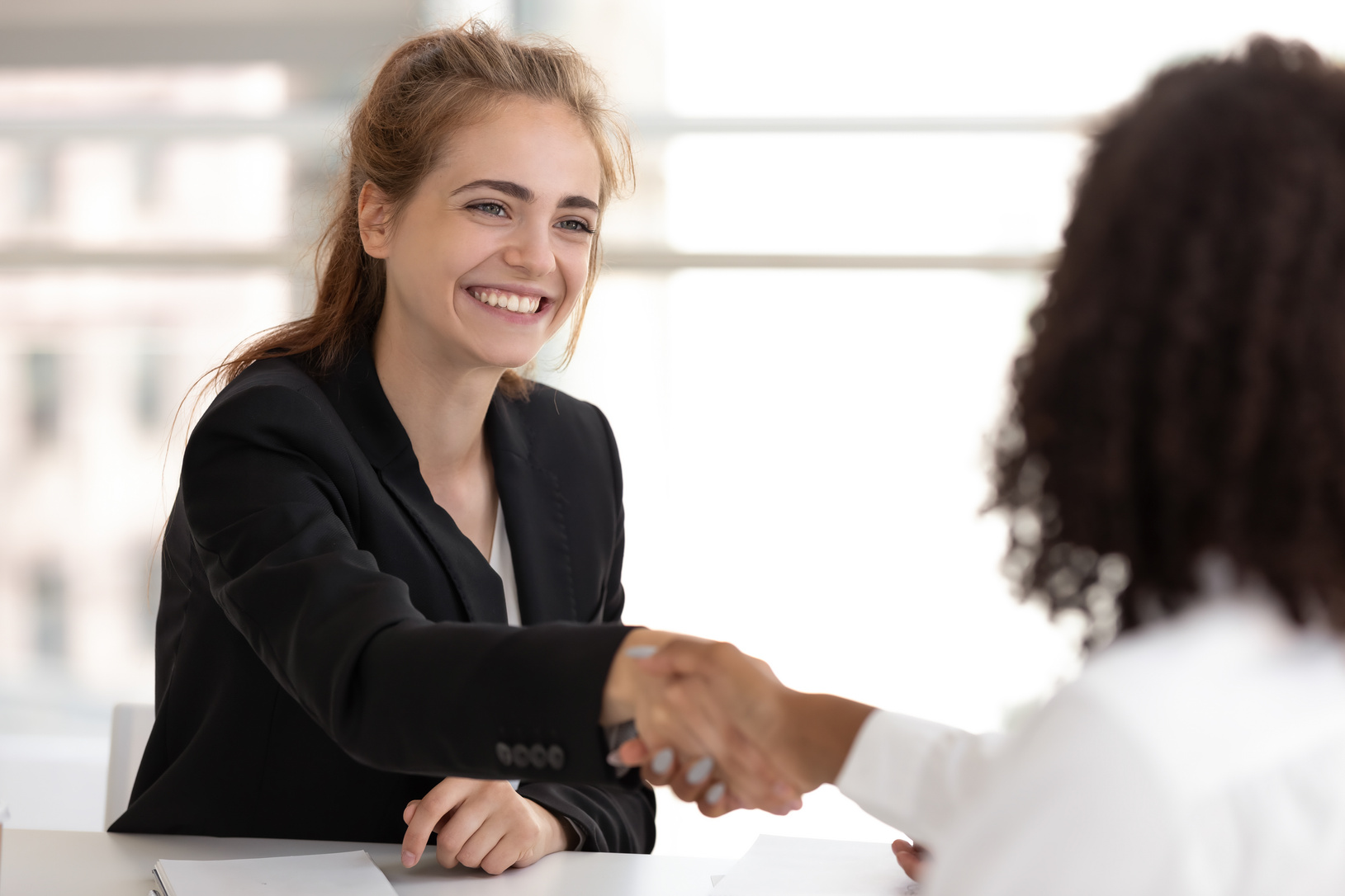 Happy businesswoman hr manager handshake hire candidate selling insurance services